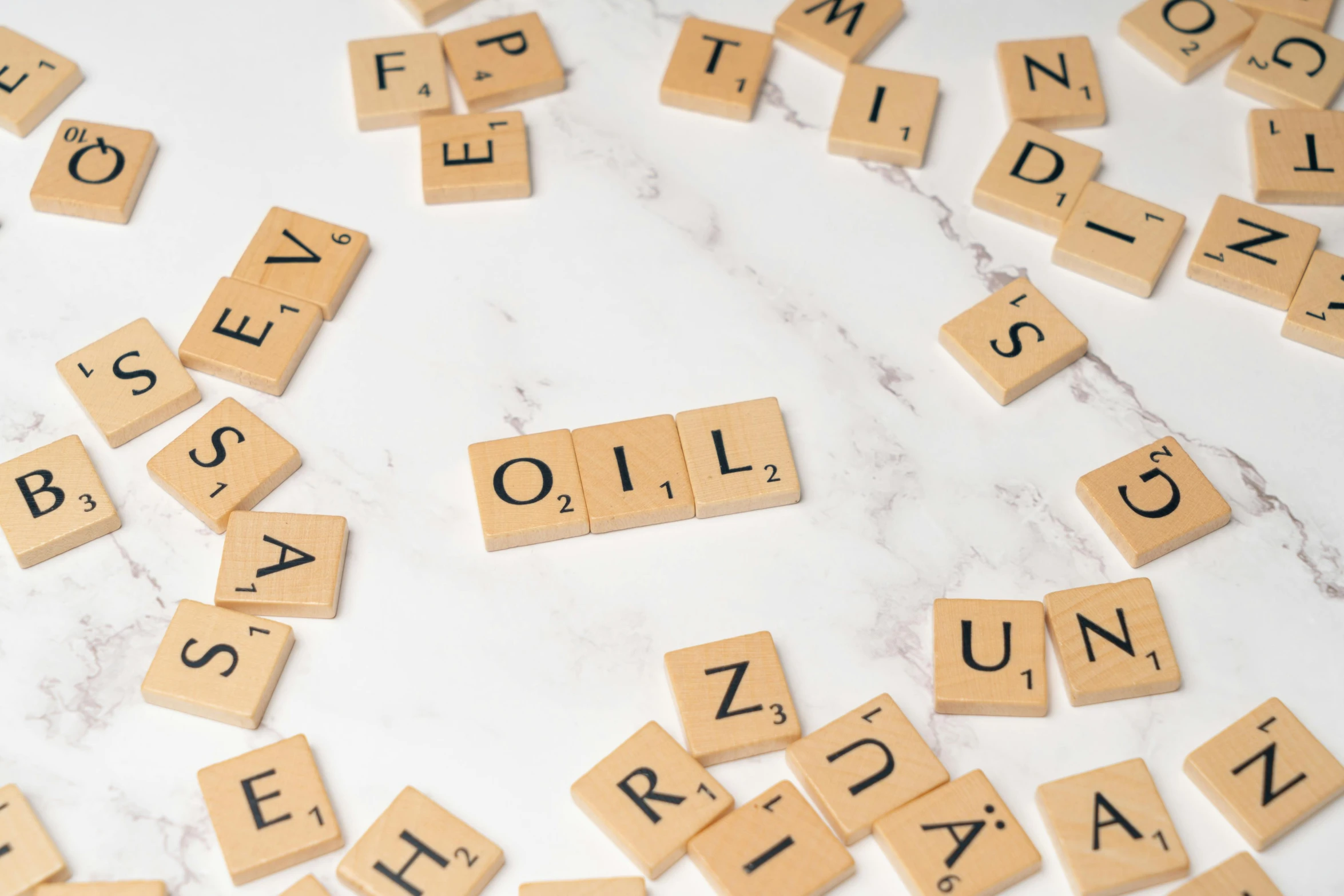 scrabble letters written on wooden blocks spelling out words and names