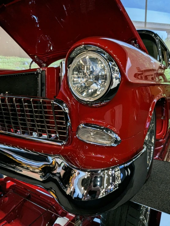 a classic car with its hood open and shiny chrome