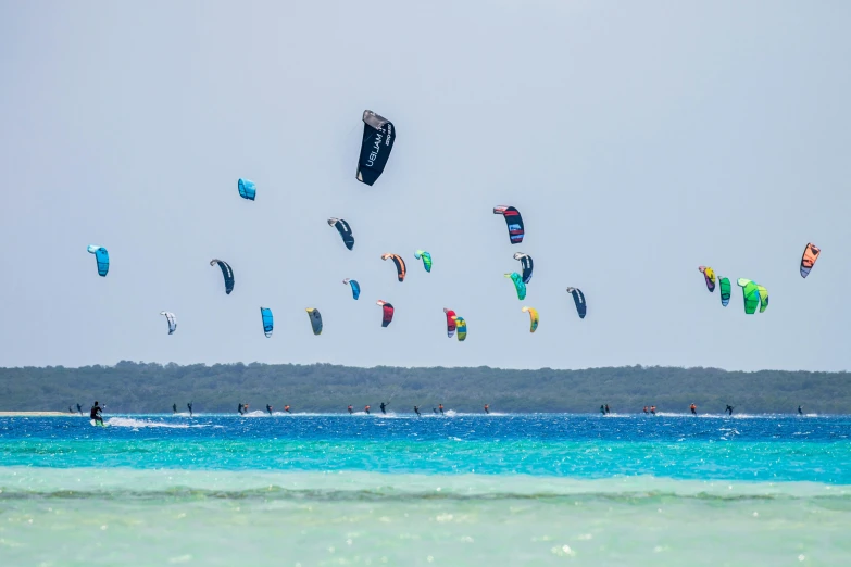 a group of para - sailers gliding over a body of water