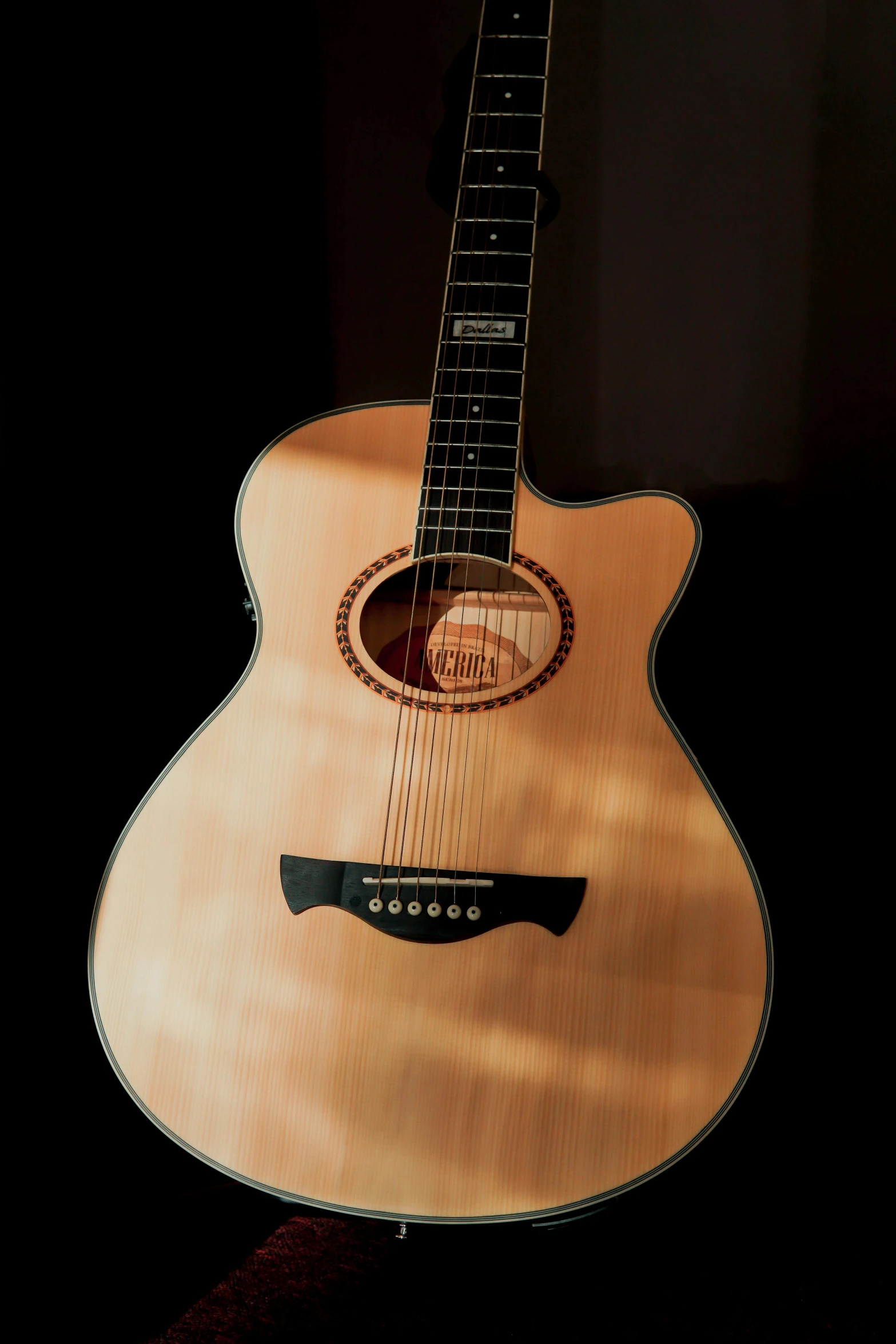 the back of an acoustic guitar with its sun glarer