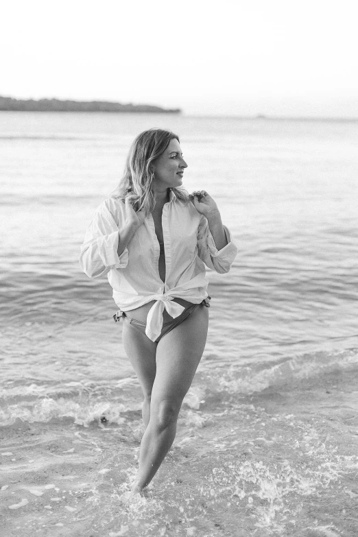 a woman is running through the water on the beach