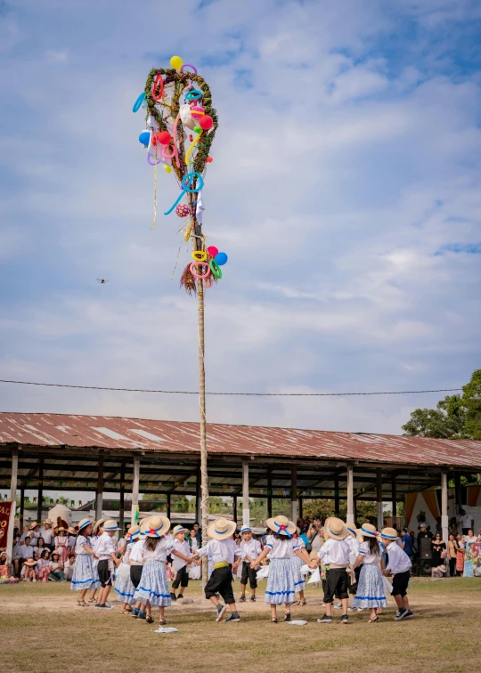 there is a group of people standing by a large balloon