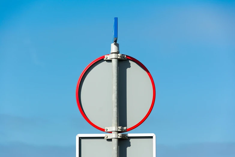 two street signs are against a light blue sky