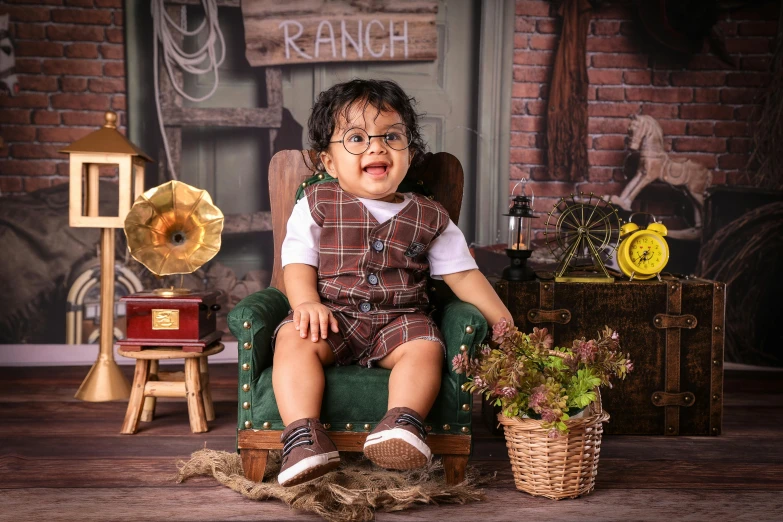 a small child sitting on a green chair in the middle of a room