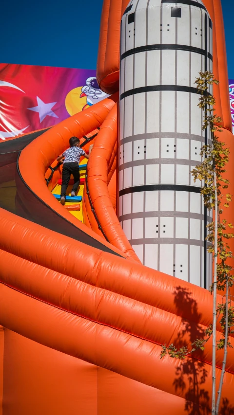 an inflatable slide next to a giant building