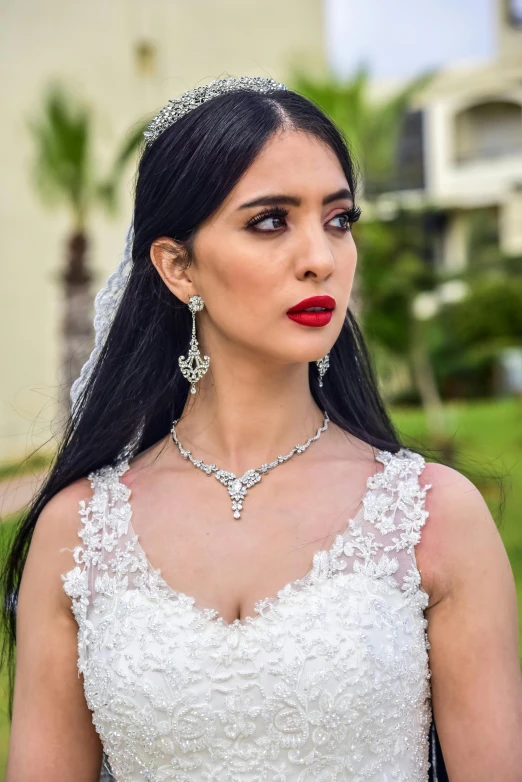 woman wearing very short dress with very long necklace and ring