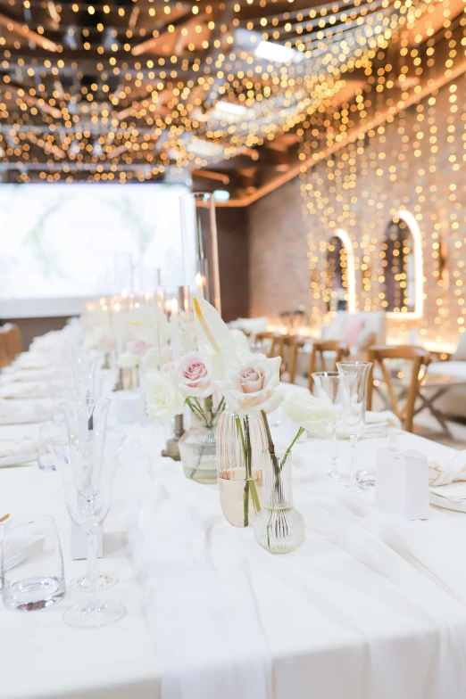 a table with flowers on it that is set for a wedding