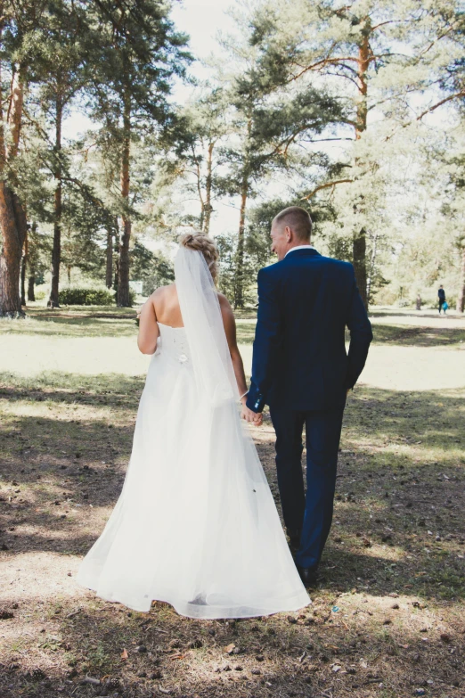 a man and a woman that are walking down a path