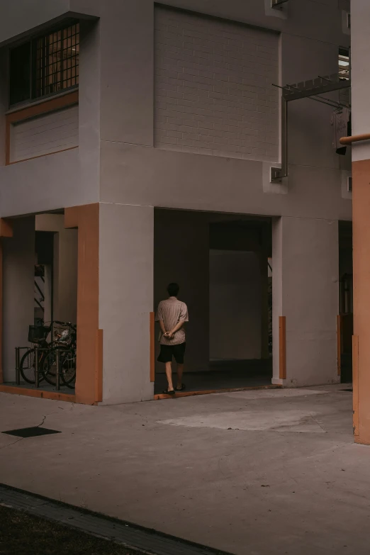 a man looking into a building through a door