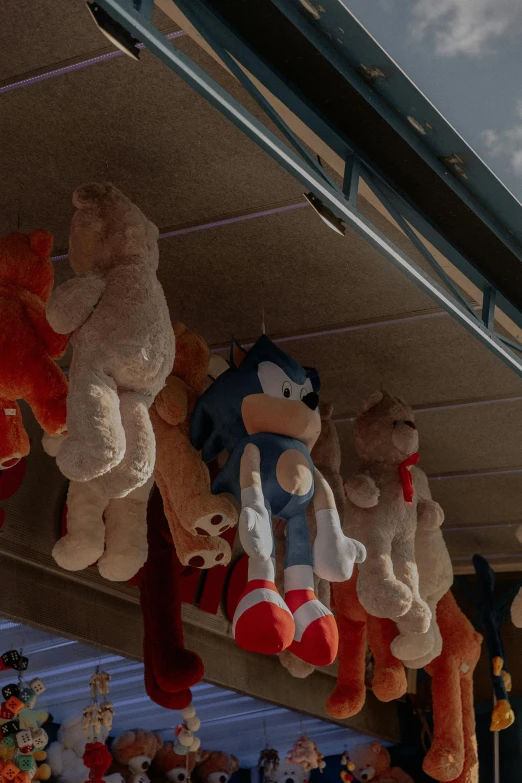 various stuffed animals hang on the clothesline in a closet