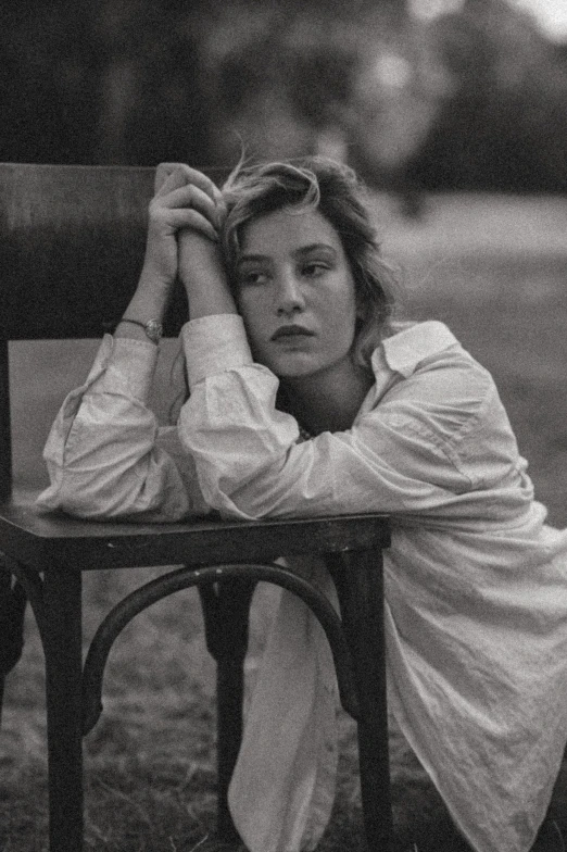 woman leaning on bench with arms over her head