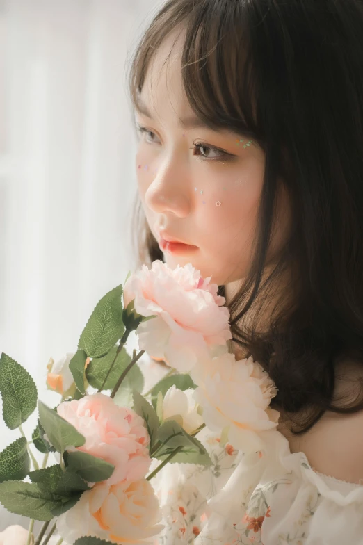 a close up view of a girl holding pink flowers