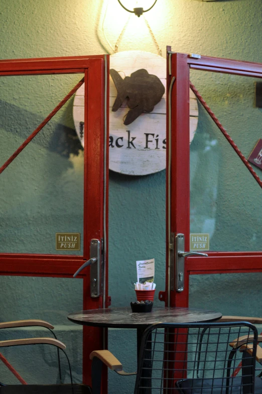 a table with some books is in front of a closed door