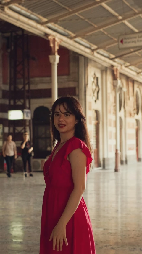 a woman standing inside of a building with a smile