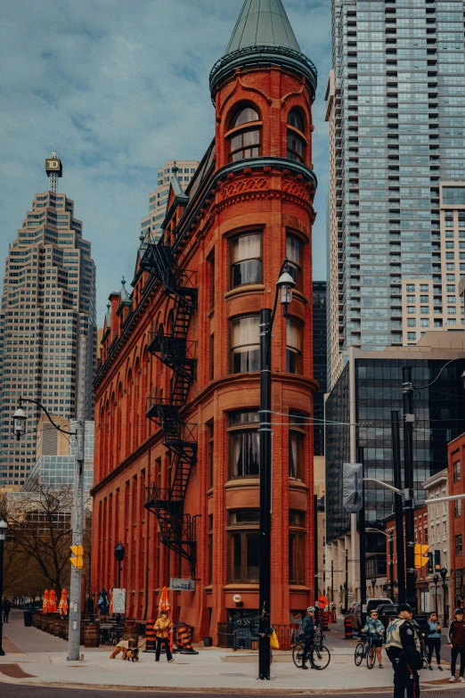 a very old red brick building in an urban setting