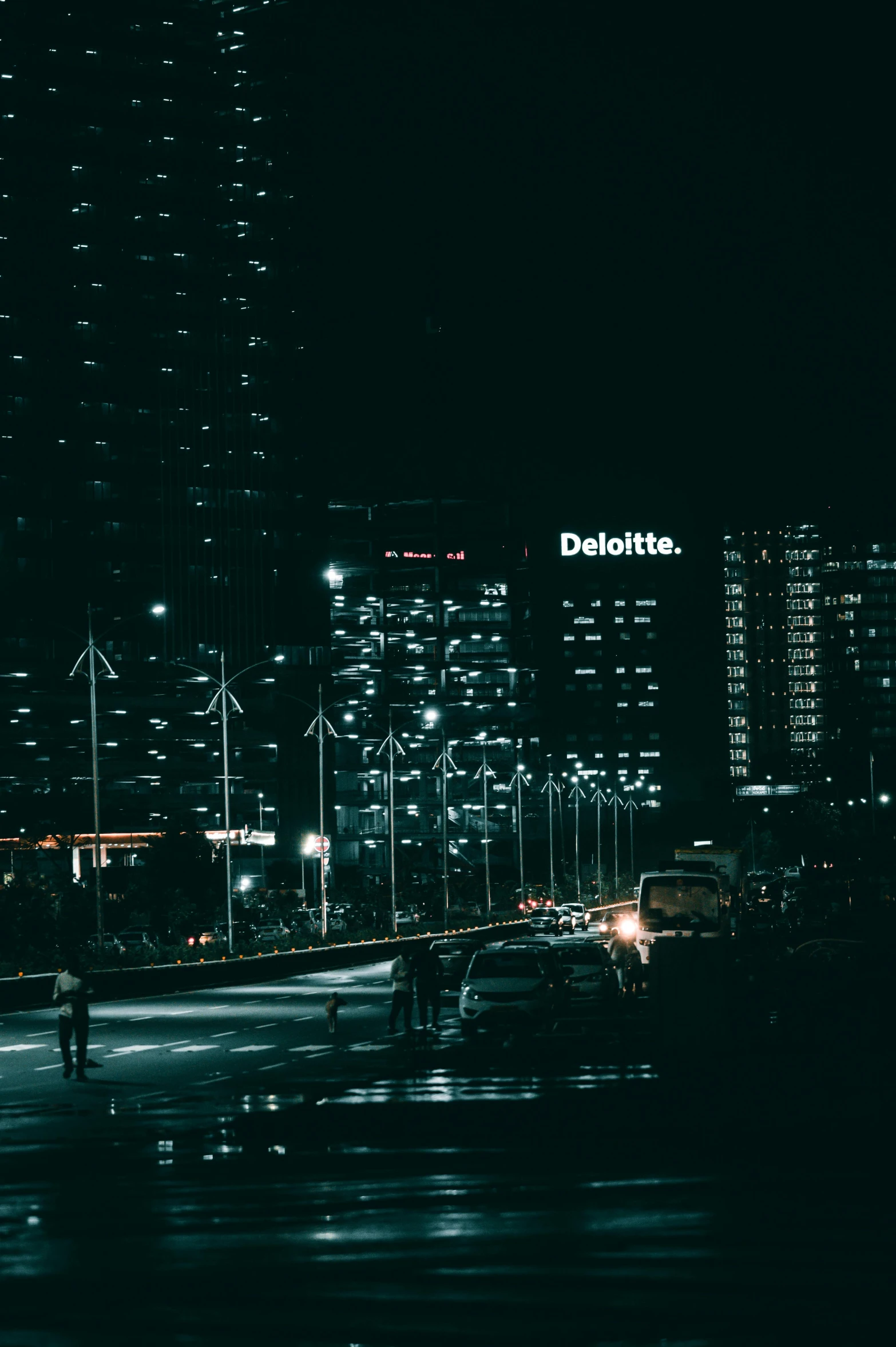 a night scene with people, buildings and street lights