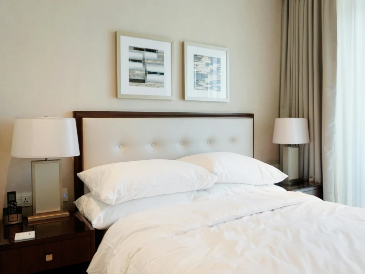 an image of a bed room setting with white bed linens