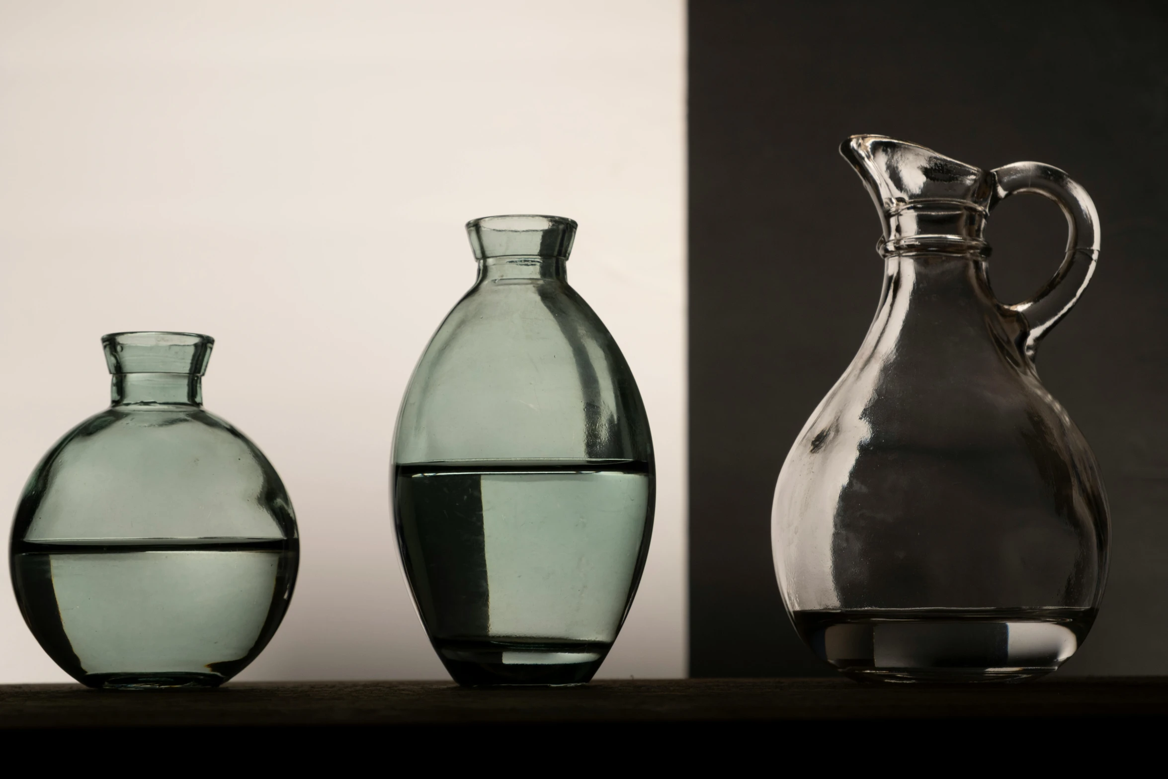 two clear vases sit side by side on a table