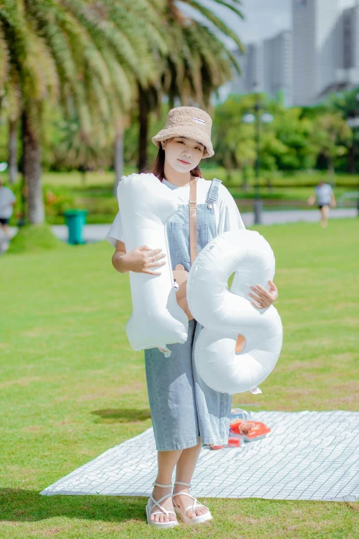 a person standing on a field with some air balloons