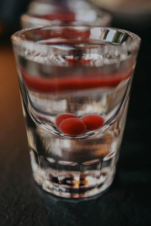three clear glass filled with soing red on top of a table