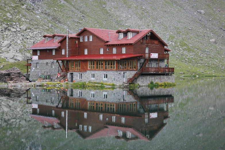 the building is located in a mountain by the water