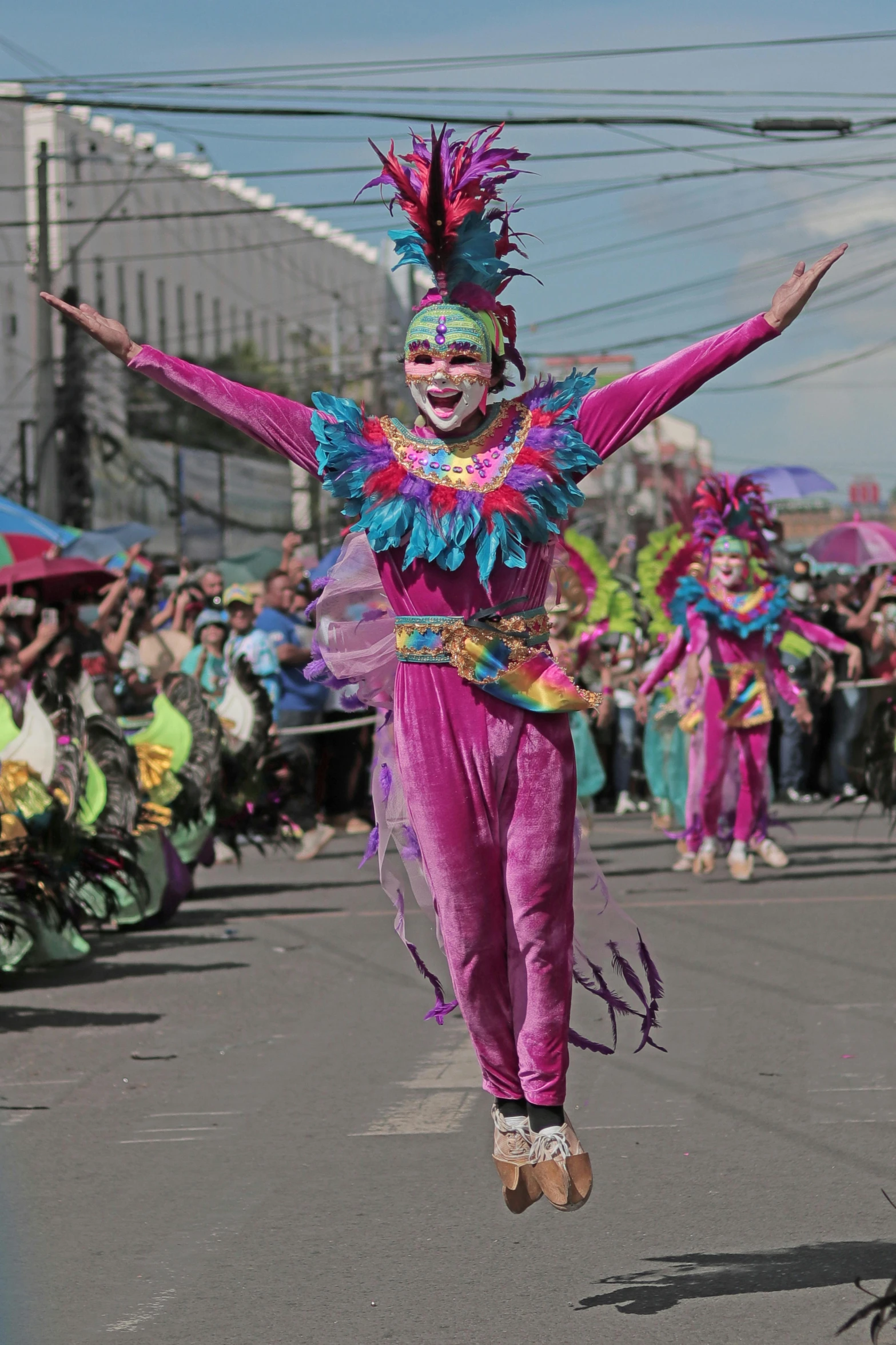 people running on the street wearing clown costumes