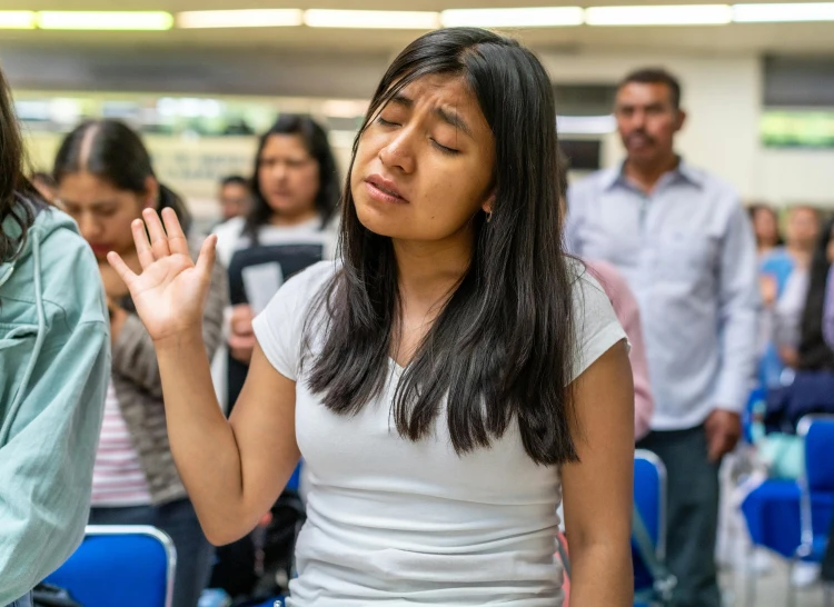 a girl holds her hand out while talking to the audience