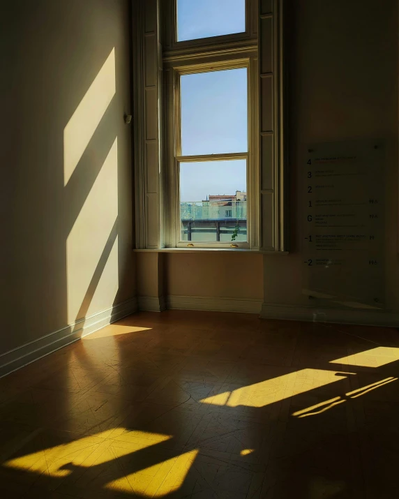 an empty room with sunshine shining on the floor