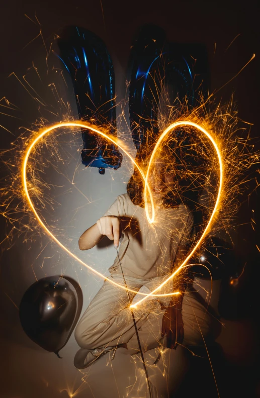 there is a man sitting with sparklers on his lap