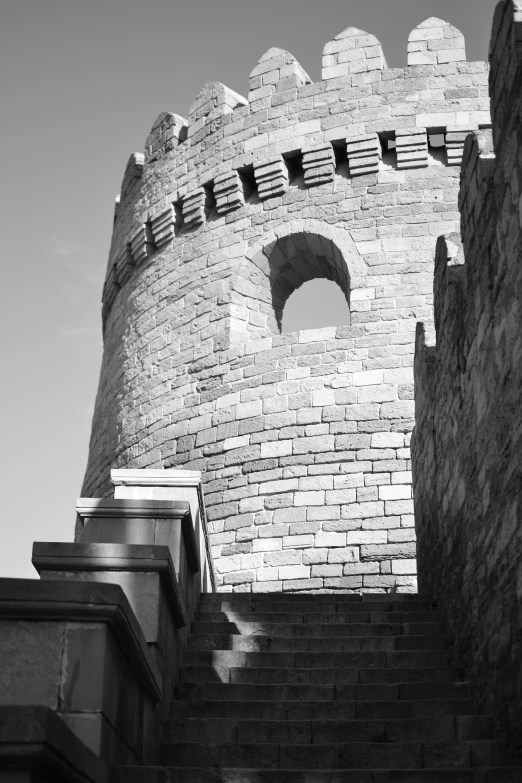 a close up of a tall stone tower with a clock on it