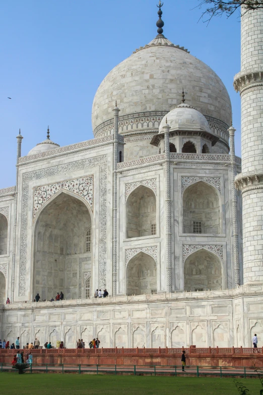 a white mosque with multiple arches and doorways