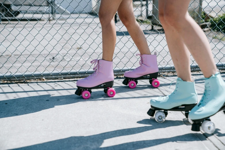 girls in boots and rain boots riding on roller skates