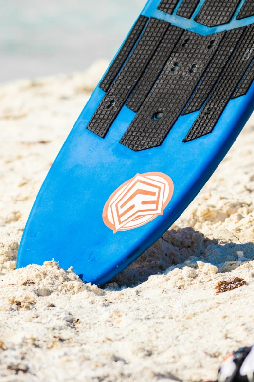 a surfboard sticking out of the sand at the beach