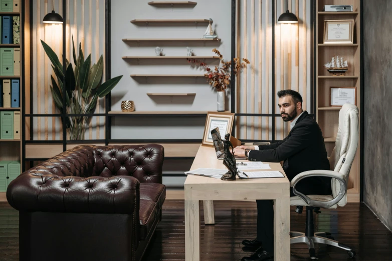 a man in a business suit is at his desk