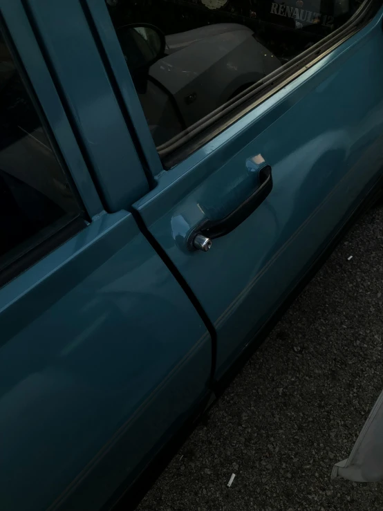 the door handle on a car that is parked in the lot