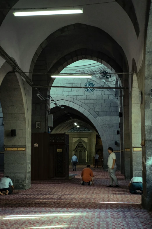 people in a building with a bunch of arches on them