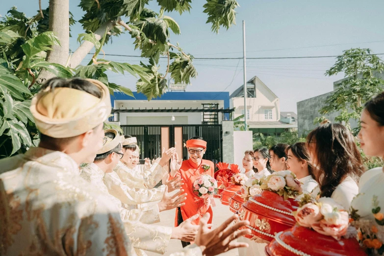 the ceremony is taking place outside in front of many guests