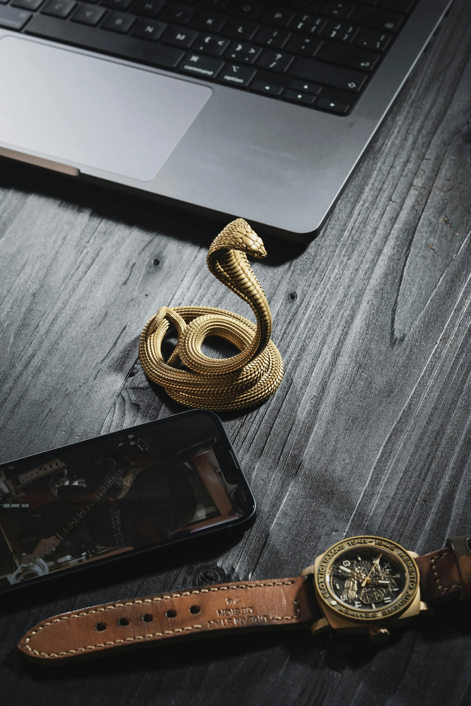 an animal's head is next to a watch and phone on a table