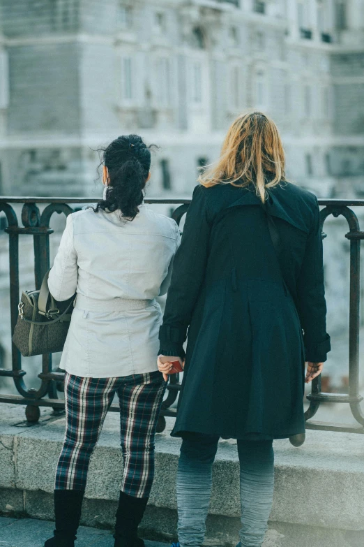 two women walk down the street together