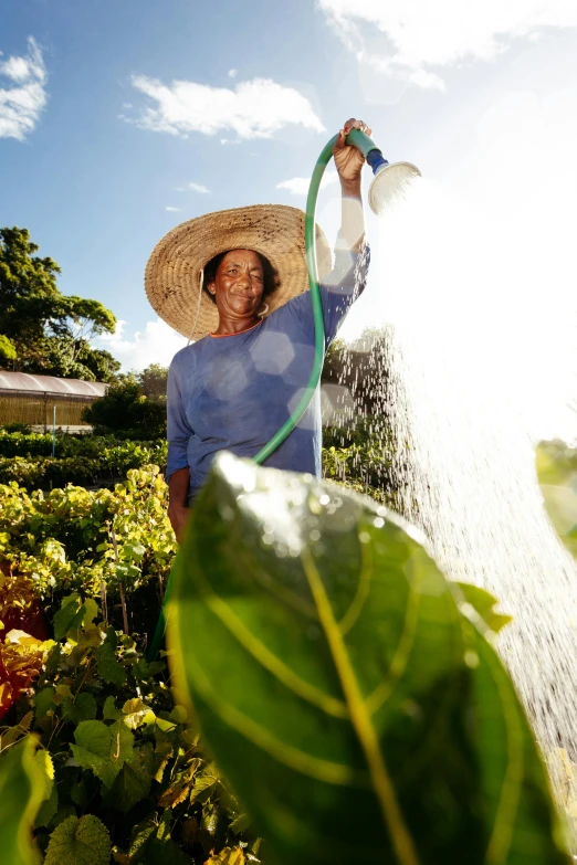 a man is holding a hose to water a field