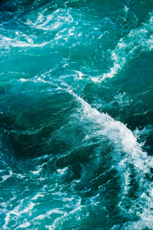 a close - up s of the ocean waves, looking down on the water