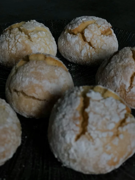 a bunch of round pastries sitting on a cooling rack