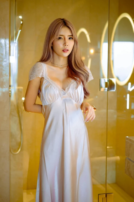 a  woman wearing a white night dress standing next to a shower