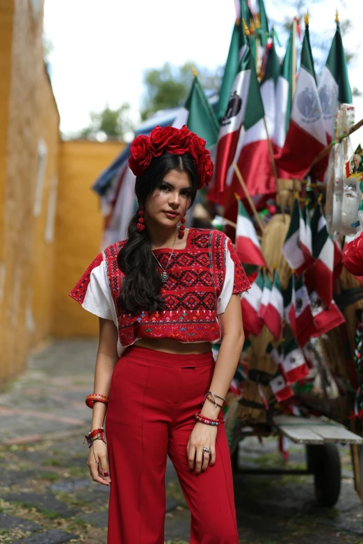 a young woman wearing red clothes and headdress