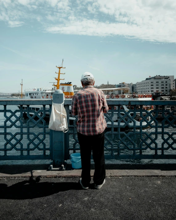 a man on a street looking over the water