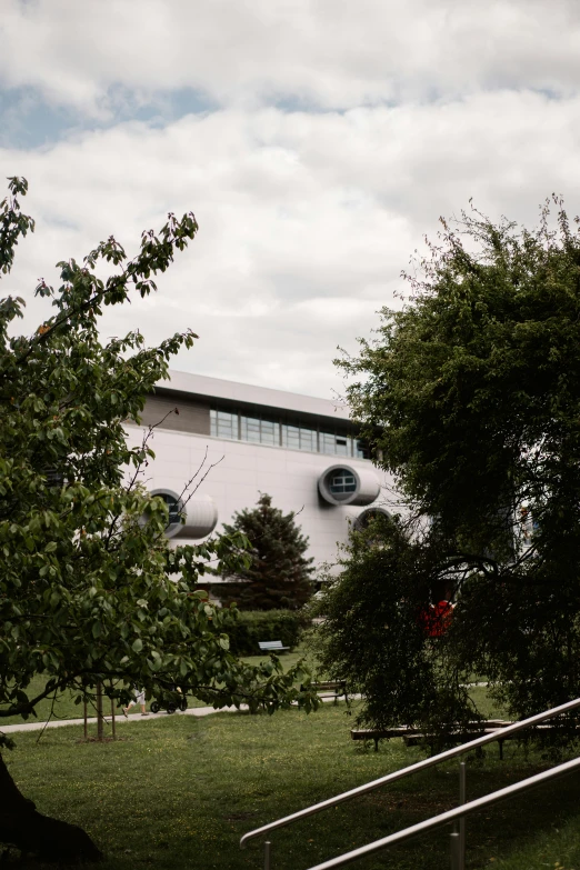 an exterior view of the building seen through some trees