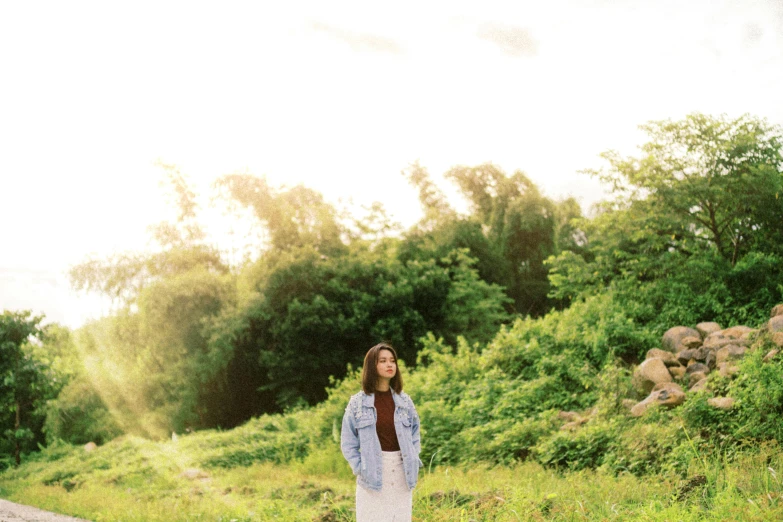 a woman standing on the side of a road