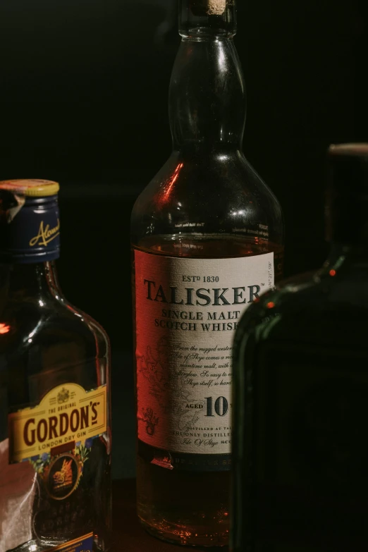 a bottle of talsker with a glass and an empty bottle