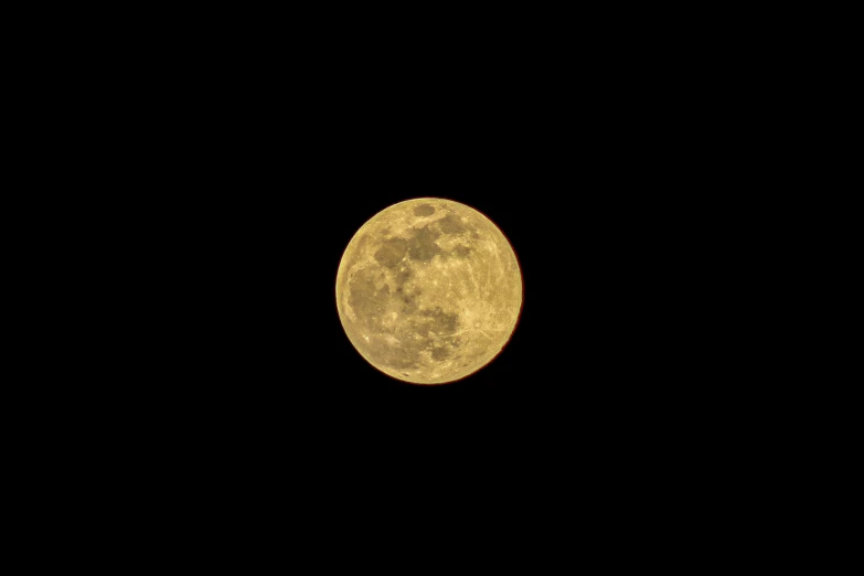 full moon with no clouds lit up in the dark
