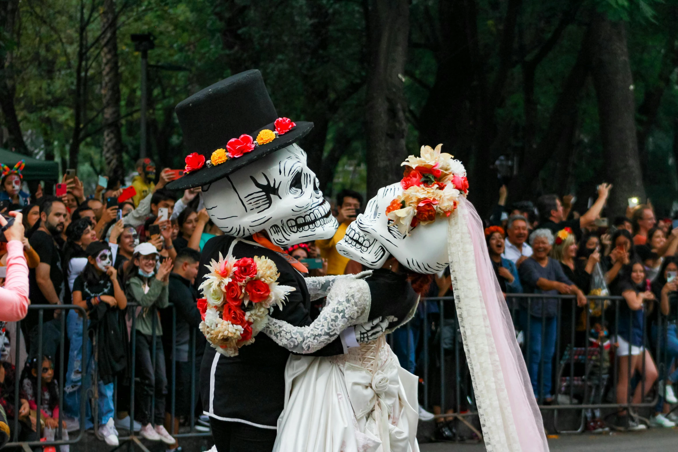 a skeleton and a bride are performing in a parade